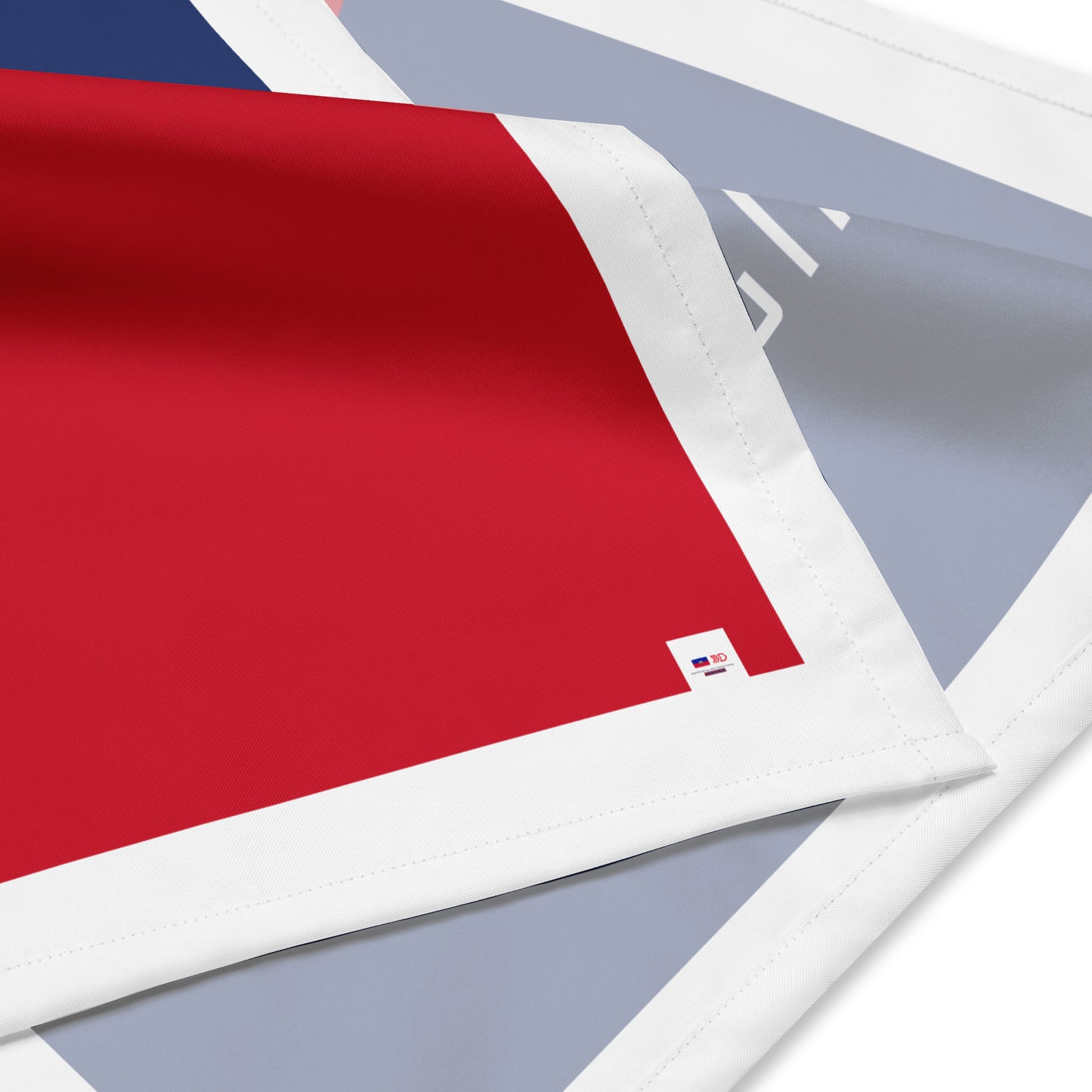 Close-up of a red fabric with a small logo on a white background