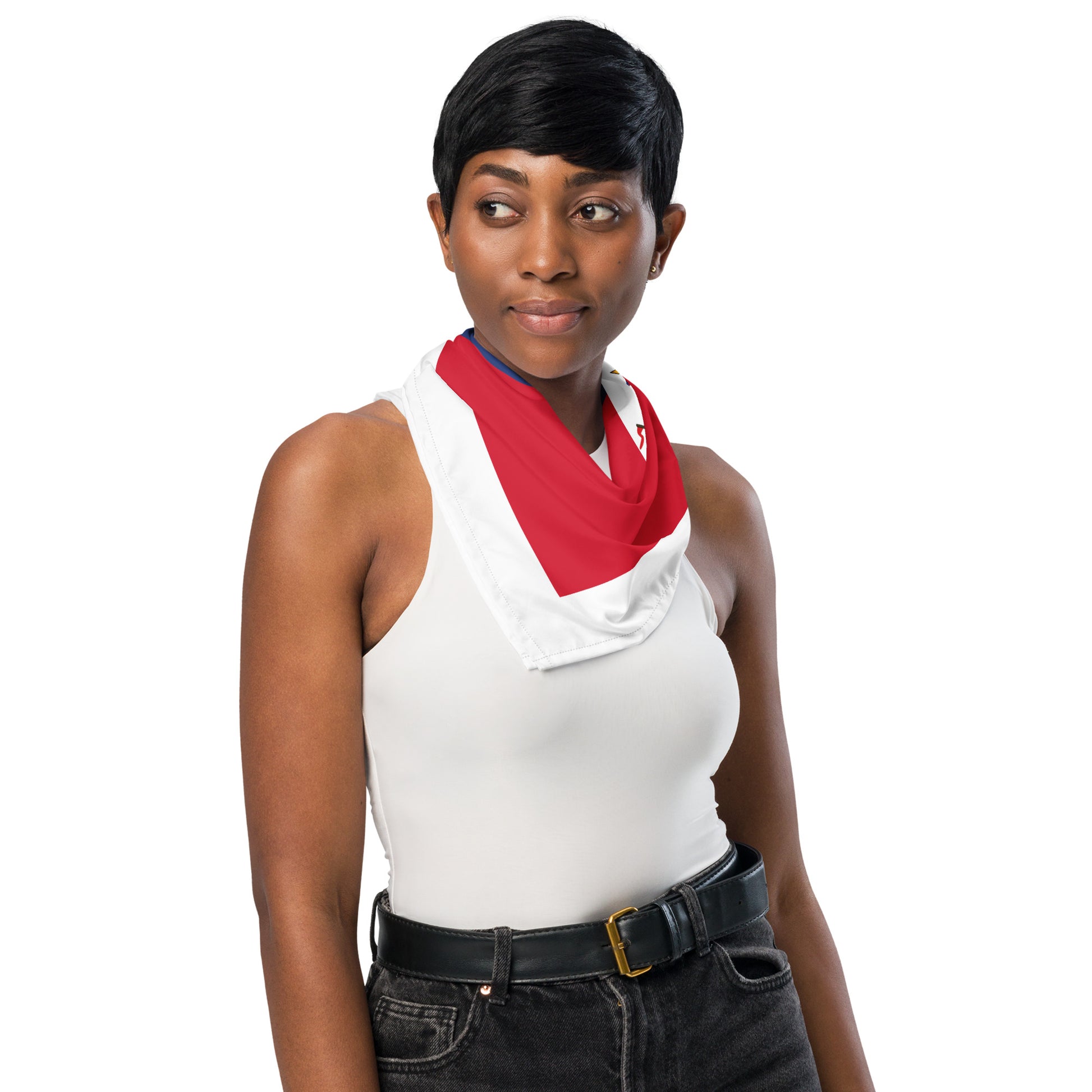 Woman wearing a white sleeveless top with a red scarf and black pants on a white background