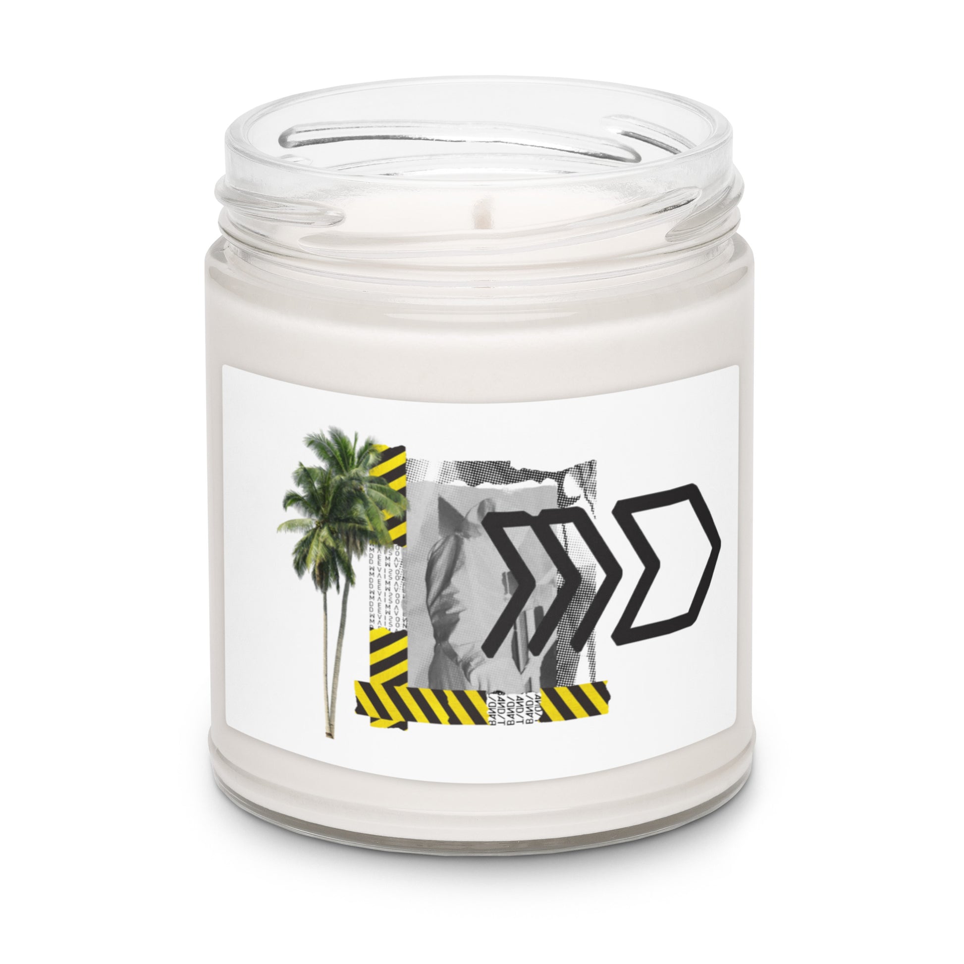 Candle in a clear jar with a label featuring palm trees and black arrows on a white background