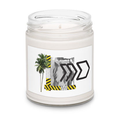Candle in a clear jar with a label featuring palm trees and black arrows on a white background